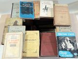 many books stacked on top of each other on a table