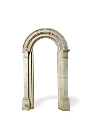 a stone arch that has a clock on top of it