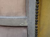 a close up of a wooden door with beads on it