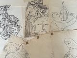 a lot of drawings on a table with a black and white picture
