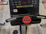 a tread machine in a gym with a monitor on it