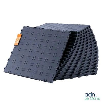 a stack of black tiles with a tag on it