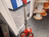 a red and black floor polisher in a room