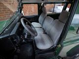 a green vehicle with a grey seat cover and a steering wheel