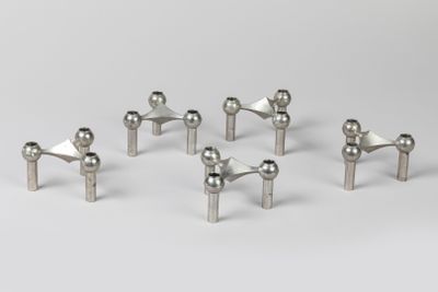 a set of six stainless steel knobs on a white surface