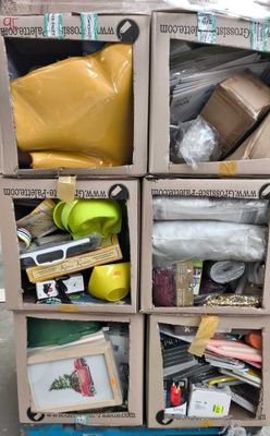 un carton rempli d'objets divers posé par terre