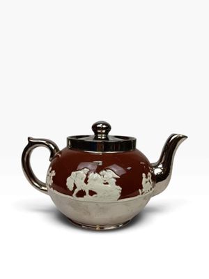 une image représentant une théière marron et blanche sur fond blanc