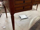 a desk with a glass top on the floor in a room