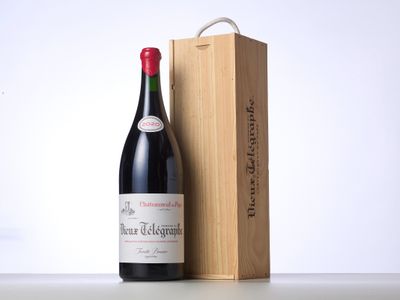 a bottle of wine sitting next to a wooden box