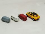 three toy cars are lined up in a row on a white surface