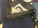 a lot of ties that are laying on a bed