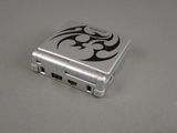 a small metal device with a tribal design on it