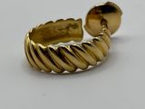 a close up of a gold ring on a white surface