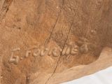 a close up of a piece of wood with writing on it