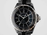 the watch is black and silver with a black face