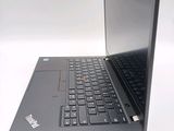 a laptop with a black keyboard on a white surface