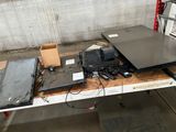 several laptops are sitting on a table in a warehouse