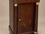 an old wooden cabinet with a marble top and brass handles