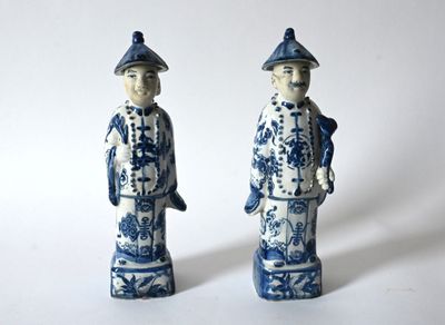 pair of blue and white figurines of a man and a woman