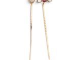 a pair of chopsticks with red and white stones on them