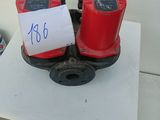 two red fire hydrants sitting on a white table