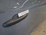a close up of a car door handle with a sticker on it