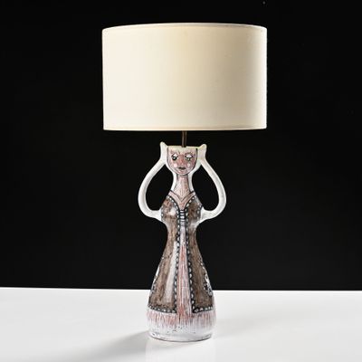 a lamp that is sitting on a table in front of a black background