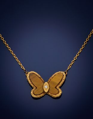 a gold butterfly necklace with a diamond on a chain