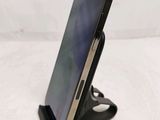 a cell phone that is on a stand on a table