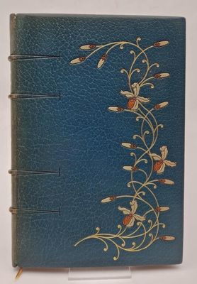 an old book with a blue cover and gold flowers on it