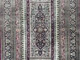 an oriental rug with a pink border and a black border