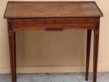 a small wooden table with a drawer on top of it