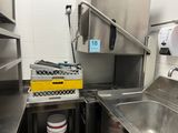 a kitchen with a sink and a metal counter