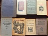 several books are sitting on a table in a row on top of each other