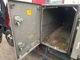 a metal box with a door open on the side of a truck