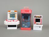 two small toy video game consoles sitting next to each other