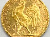 an image of a gold coin with a rooster on it