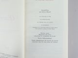 a person holding a book open on a table