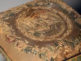 a small wooden stool with a floral design on it