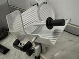 a meat slicer sitting on a counter in a kitchen
