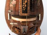 a large wooden clock with a floral design on it