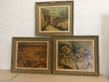 three paintings on a shelf in a room