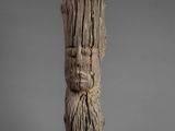 an image of a piece of wood with a face carved into it