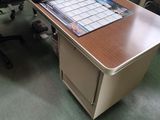 a desk with a laptop on it in an office