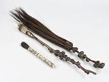 three different types of brooms and a brush on a white surface