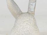 a white ceramic bunny head with a long nose