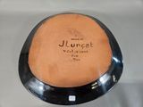 a black plate with a writing on it that says jurget