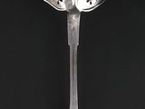 a spoon and a spoon with a flower design on it