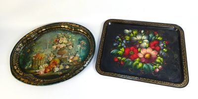 two trays with flowers on them sitting on a table