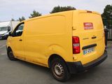 a yellow van that is parked in a parking lot